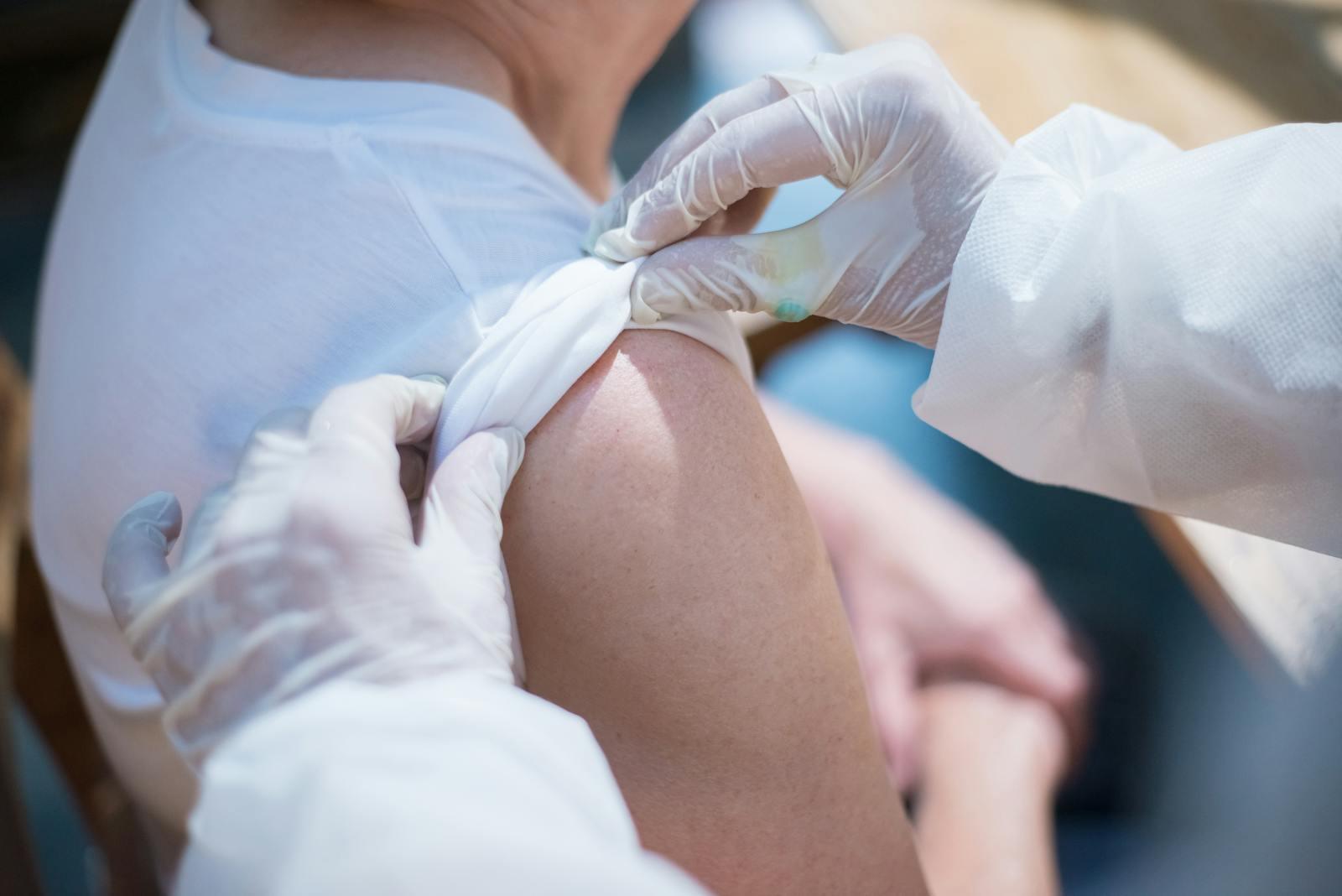 Close-up of a healthcare worker administering a vaccination to a patient in Portugal.